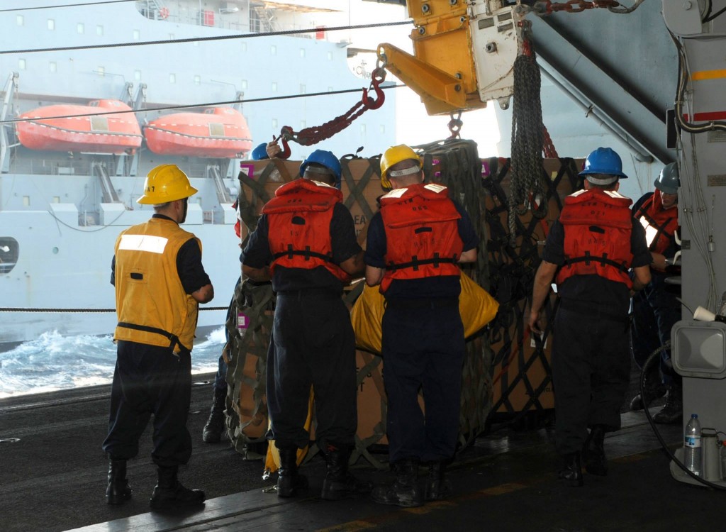 Sailors detach a pallet from a pulley during a replenishment-at-sea. (Photo: U.S. Navy photo by Mass Communication Specialist 3rd Class Margaret Keith)(Photo: 