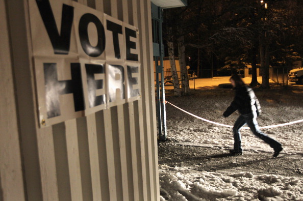 An Alaskan voter arrives to a polling station to cast her ballot before sunrise. (Photo: John Moore/Getty Images)