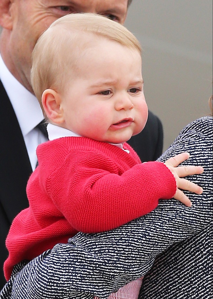 Prince George in the arms of his mother the Duchess of Cambridge (Photo: Newscom)