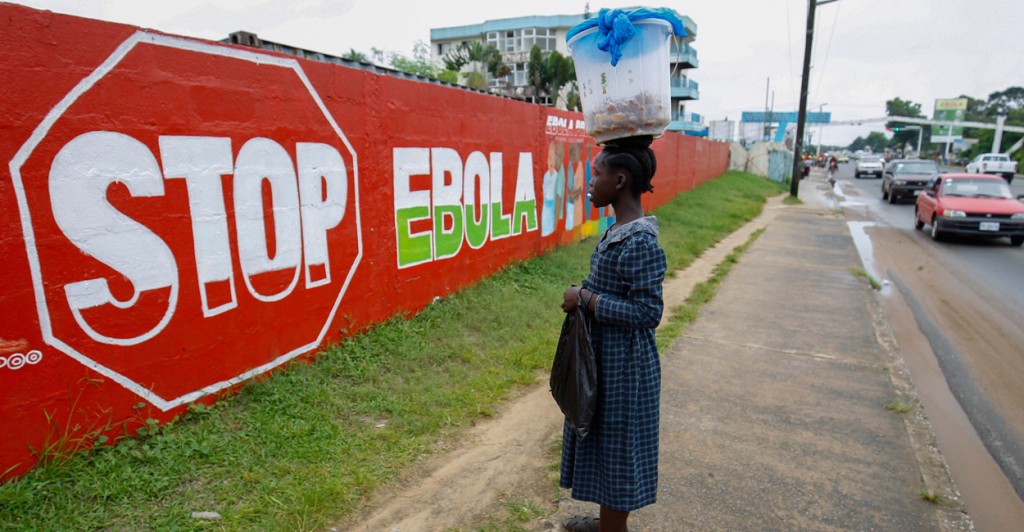 A woman looks at an Ebola sensitization mural in Monrovia, Liberia. (Photo: Ahmed Jallanzo/EPA/Newscom)