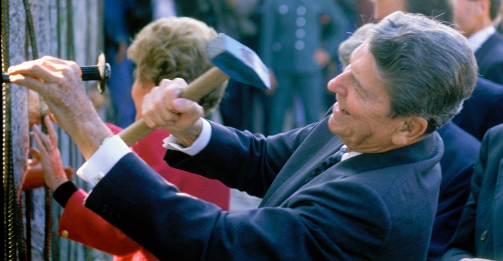 President Ronald Reagan, with his wife Nancy Reagan, hammers symbolically at an opening in the Berlin Wall, Sept. 10, 1990. (Photo: Andrew Popper/Polaris/Newscom)
