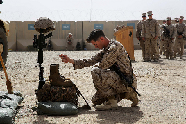 Sgt. Louis Wood pays his respects to Sgt. Thomas Z. Spitzer during a memorial ceremony aboard Camp Leatherneck. The memorial was in honor of Spitzer, a professionally instructed gunman with Scout Sniper Platoon, 1st Bn., 7th Marines, who was killed while conducting combat operations in Helmand province, Afghanistan. (Photo: Cpl. Joseph Scanlan /Released)