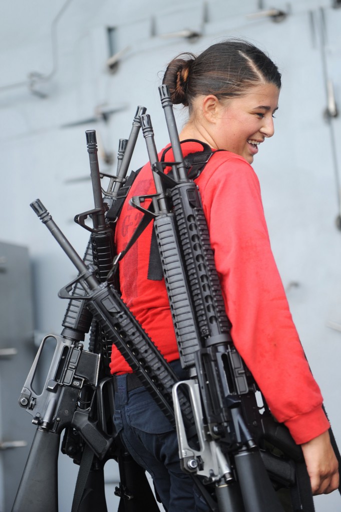In the Arabian Gulf on Aug. 14, 2014, Gunner's Mate Seaman Coren Demastus, from Fort Smith, Ark., carries rifles after training aboard the aircraft carrier. (Photo: U.S. Navy photo by Mass Communication Specialist 3rd Class Brian Stephens)