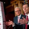 Sen. John Barrasso, R-Wyo., with Sen. Orrin Hatch, R-Utah, reveals a tower of Obamacare regulations. (Photo: Chris Maddaloni/CQ Roll Call/Newscom)