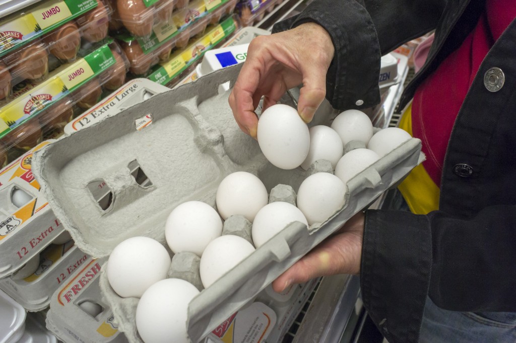 A shopper checks for broken eggs in a supermarket in New York on Wednesday, June 3, 2015. The worst outbreak of bird flu in the U.S. has caused the death of almost 45 million chickens and turkeys  causing wholesale prices to double in the last month. Over 10 percent of all the hens have died.  (© Richard B. Levine)  (Newscom TagID: lrphotos091535.jpg) [Photo via Newscom]
