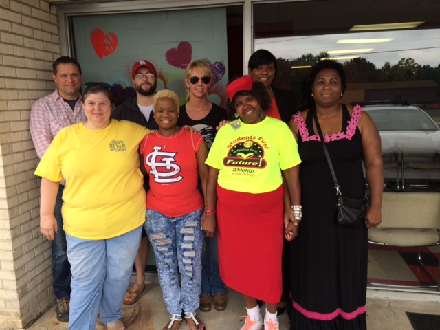 Volunteers with the St. Louis Tea Party Coalition gather with Dellena Jones outside her shop, 911 Hair Salon. The St. Louis Tea Party Coalition has been helping Jones rebuild after protests erupted in Ferguson, Mo., last year and again on Sunday. (Photo: Dottie McKenna Bailey)