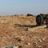 A fighter with the U.S.-backed Free Syrian Army stands Oct. 16 near a weapon aimed at  forces loyal to  the nation's dictator, Bashar al-Assad, in Deraa, Syria. (Photo: Reuters/Newscom)