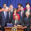 President Obama signs an education bill that Sen. Lamar Alexander, third from left at front, says could be the model for a 'fix' to Obamacare. (Photo: Cheriss May/Zuma Press/Newscom)