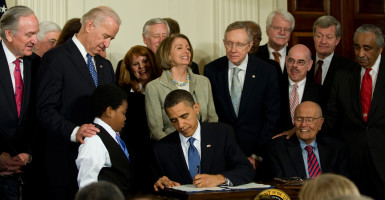 President Barack Obama signs the Affordable Care Act into law on March 23, 2010. (Photo: Pete Marovich/ZUMA/Newscom)
