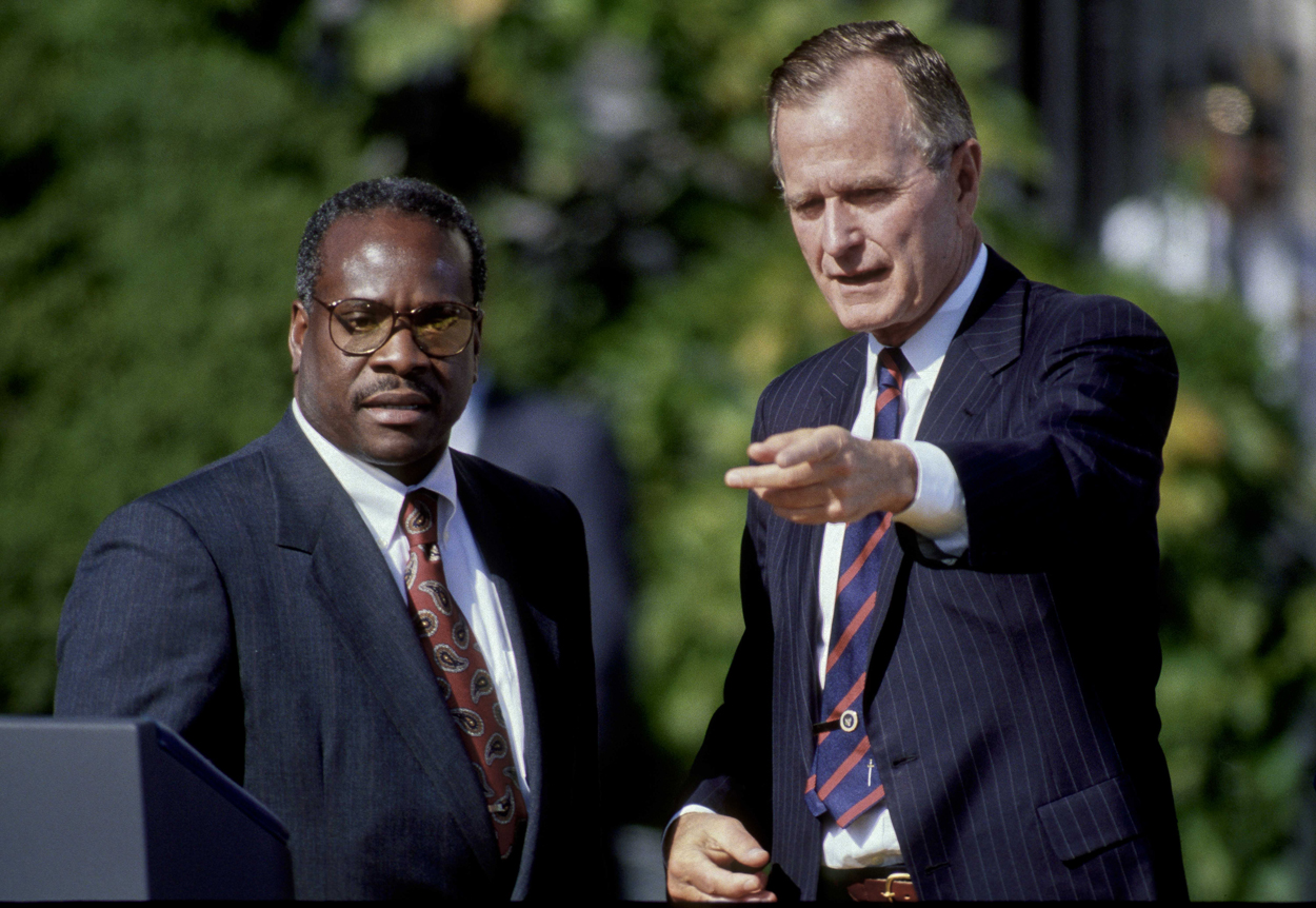 President George H.W. Bush with Clarence Thomas after he was sworn in as a Supreme Court justice. (Photo: Mark Reinstein/ZUMA Press/Newscom)