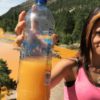 In this 2015 photo, Rayna Willhite holds a bottle of water she collected from the Animas River, which was carrying mine waste from the Gold King Mine. (Photo: Jerry McBride/The Durango Herald / Polaris/Newscom)