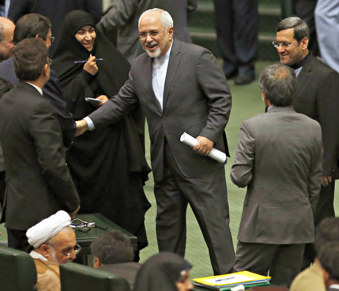 Iranian Foreign Minister Mohammad Javad Zarid greets lawmakers as he arrives for a parliament session in Tehran. (Photo: EPA/Newscom) 