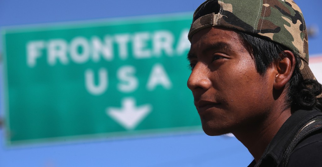 An immigrant walks near the U.S.-Mexico border. (Photo: John Moore/Getty Images)