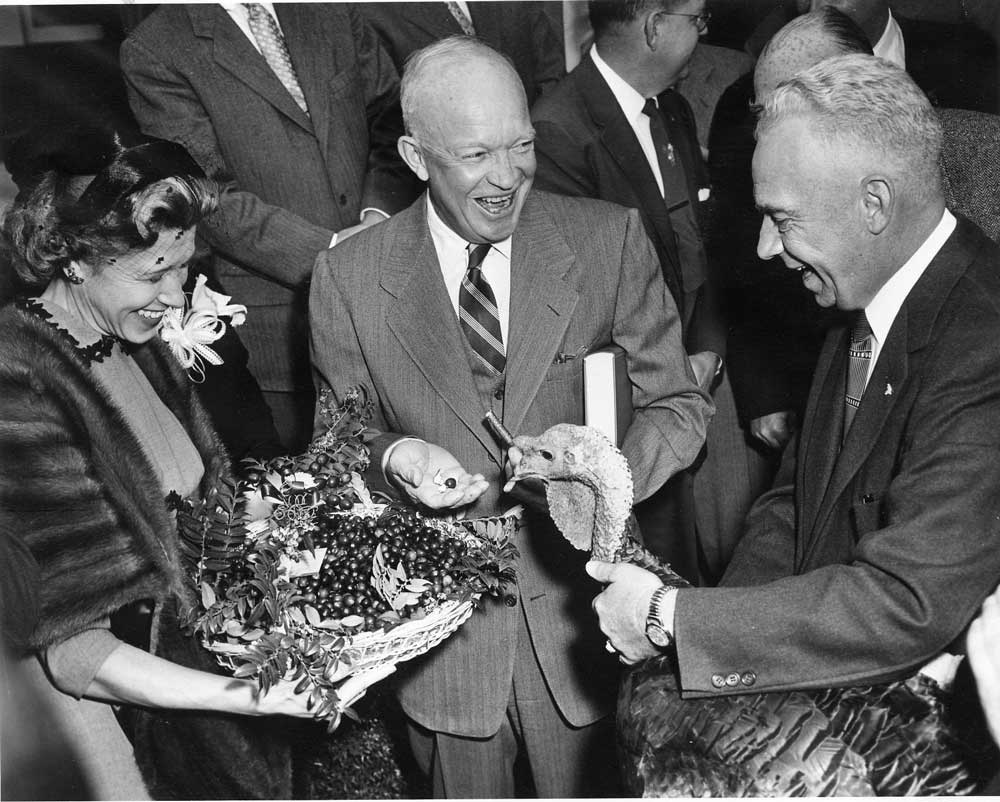 President Dwight D. Eisenhower receives a 43-pound turkey from Perry Browning of Winchester, Ky., president of the National Turkey Federation. Eisenhower holds the book, 'Turkey Management,' which was also presented. (Photo: Archives/Eisenhower Presidential Library)