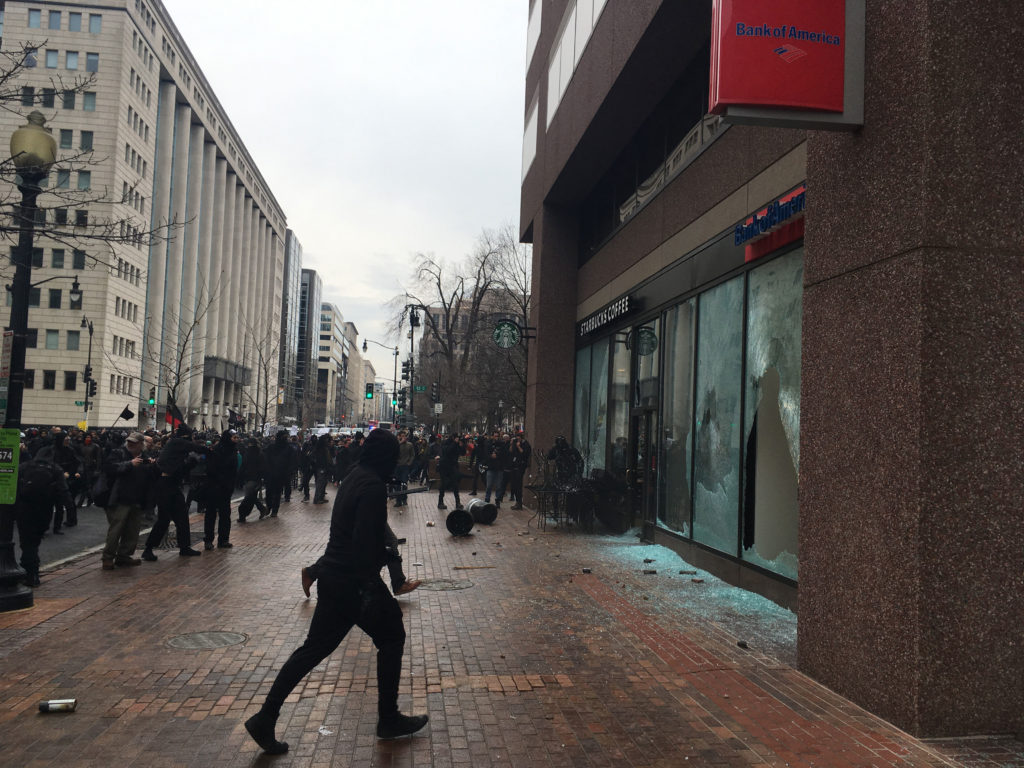 The window of a Bank of America branch in Washington, D.C. is smashed as violence erupts during the march against Trump's inauguration. (Photo: Josh Stafford/newzulu/Newscom) 