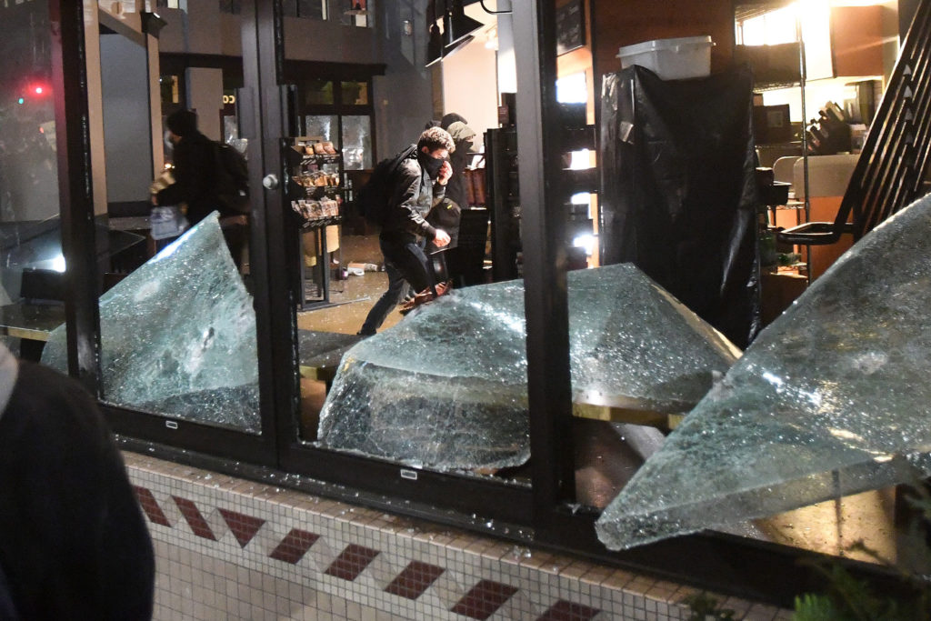 Rioters loot and vandalize a Starbucks during a protest against Yiannopoulos in Berkeley, California. (Photo: Noah Berger/EPA/Newscom)