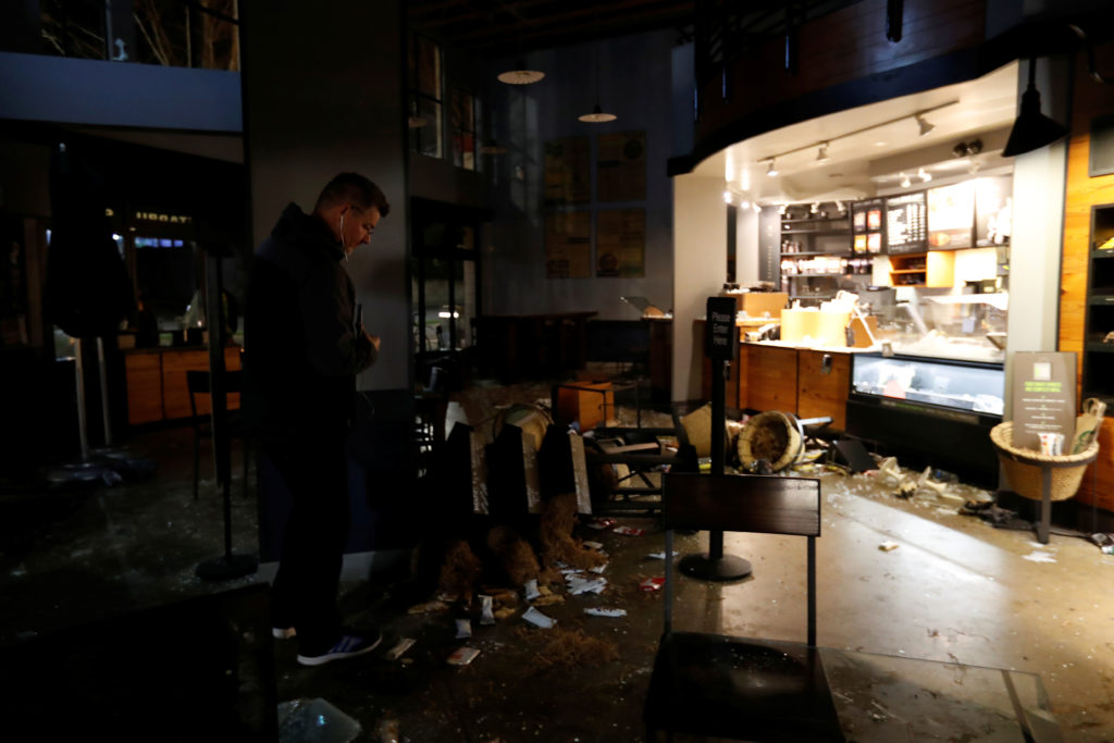 A worker surveys the damage to a vandalized Starbucks after a protest turned violent at UC Berkeley during a demonstration over Yiannopoulos in Berkeley, California. (Photo: Stephen Lam/Reuters/Newscom)