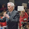 Rep. Tom McClintock, R-Calf., is interrupted as he tries to field questions Feb. 4 from an audience of about 150 in Rosevillle, California.  Anti-Trump  demonstrators chanted slogans, carried signs, and blocked traffic outside. (Photo: Randall Benton/ZumaPress/Newscom)