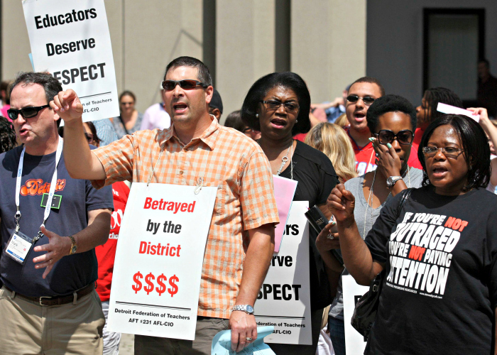 Detroit public school teachers Mark Moran and Debora Jones join fellow union members in a rally July 27, 2012, about contract talks. (Photo: Rebecca Cook/Reuters/Newscom)