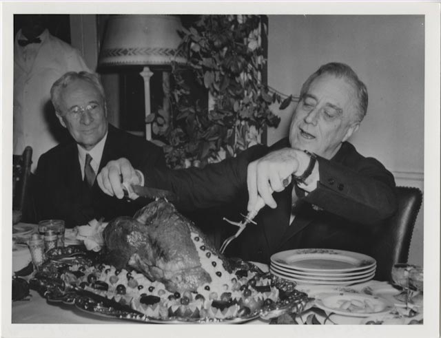Photograph of Franklin D. Roosevelt carving the Thanksgiving turkey. November 20, 1933. (Photo: U.S. National Archives and Presidential Libraries)