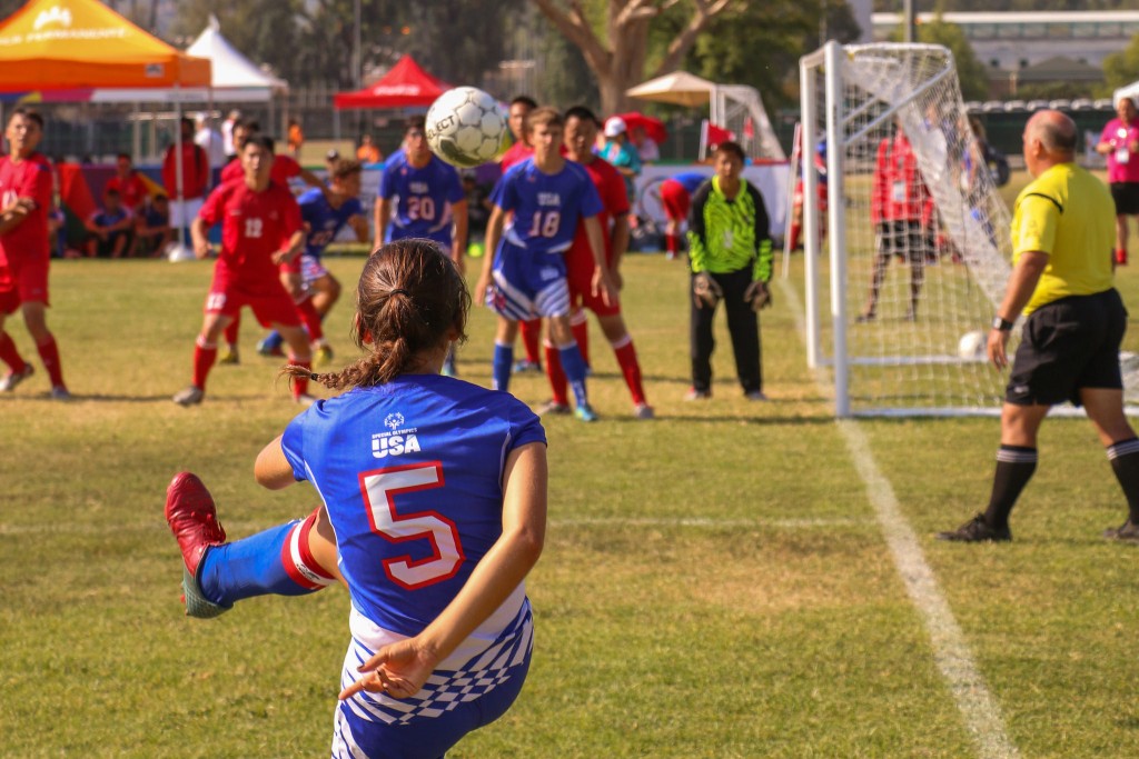 A soccer player for USA kicks a corner kick during her match. (Photo: Flickr/SpecialOlympicsUSA)