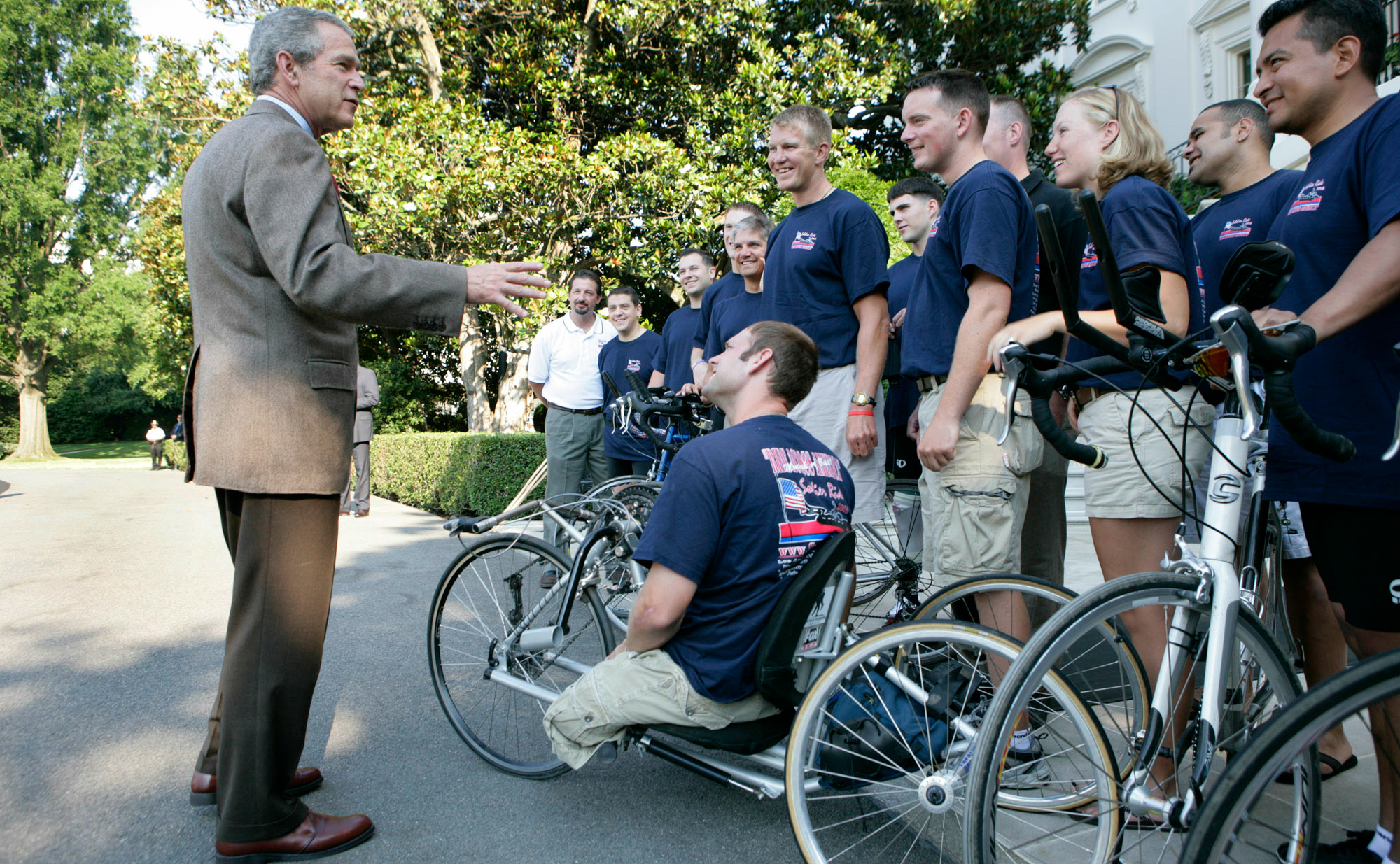 George W. Bush speaks with members of Soldier Ride 2005 National Tour Team. Soldier Ride 2005, comprised of wounded service members, is a 4,200-mile, cross-country bike ride to raise money and support to help prepare wounded soldiers for long-term rehabilitation. (Photo: Eric Draper/White House/ZUMA Press/Newscom)
