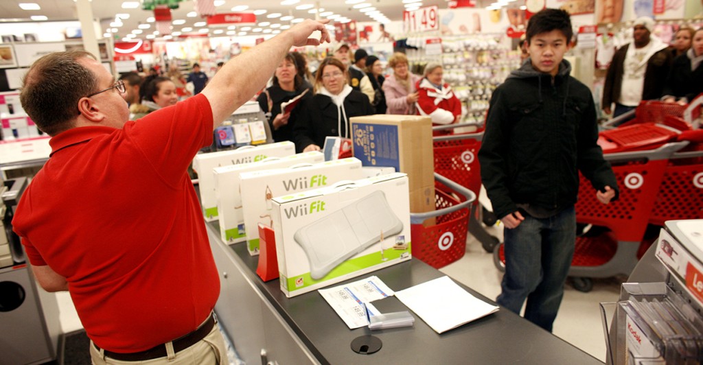 Holiday shoppers queue to make their purchases after braving the crowds in Target. (Photo: Getty Images)