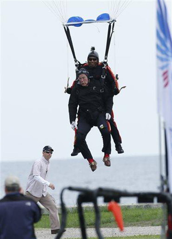 Bush lands after making a parachute jump on his 90th birthday. (Photo: The Eagle via Twitter)