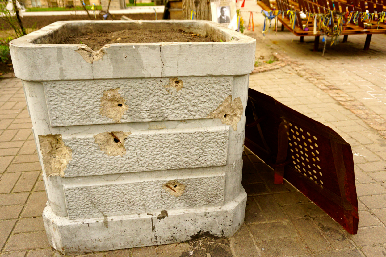 Bullet holes pockmark a planter on Institutskaya Street in central Kyiv.