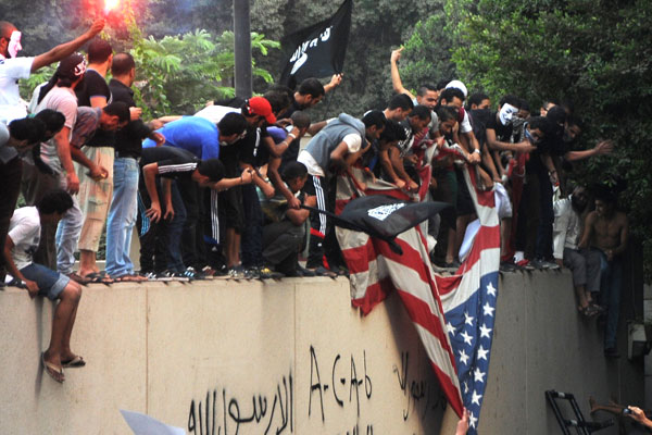 Egyptian protesters tear down the US flag at the US embassy in Cairo (Photo: STR-/AFP/GettyImages)