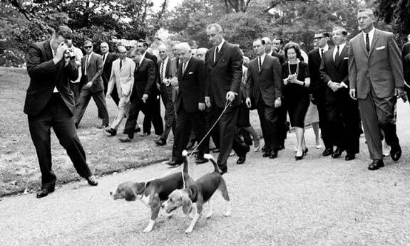 President Lyndon B. Johnson takes dogs Him and Her on a walk with the press, Aug. 18, 1964. (Photo: LBJ Library/Cecil Stoughton)