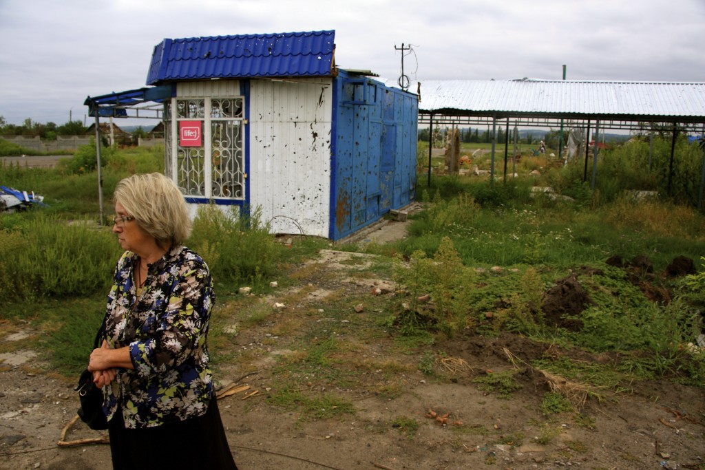 Alexandra, 63, waits for a bus in Semyonovka, the scene of intense fighting between Ukrainian and combined Russian-separatist forces in summer 2014. (Photo: Nolan Peterson/The Daily Signal)