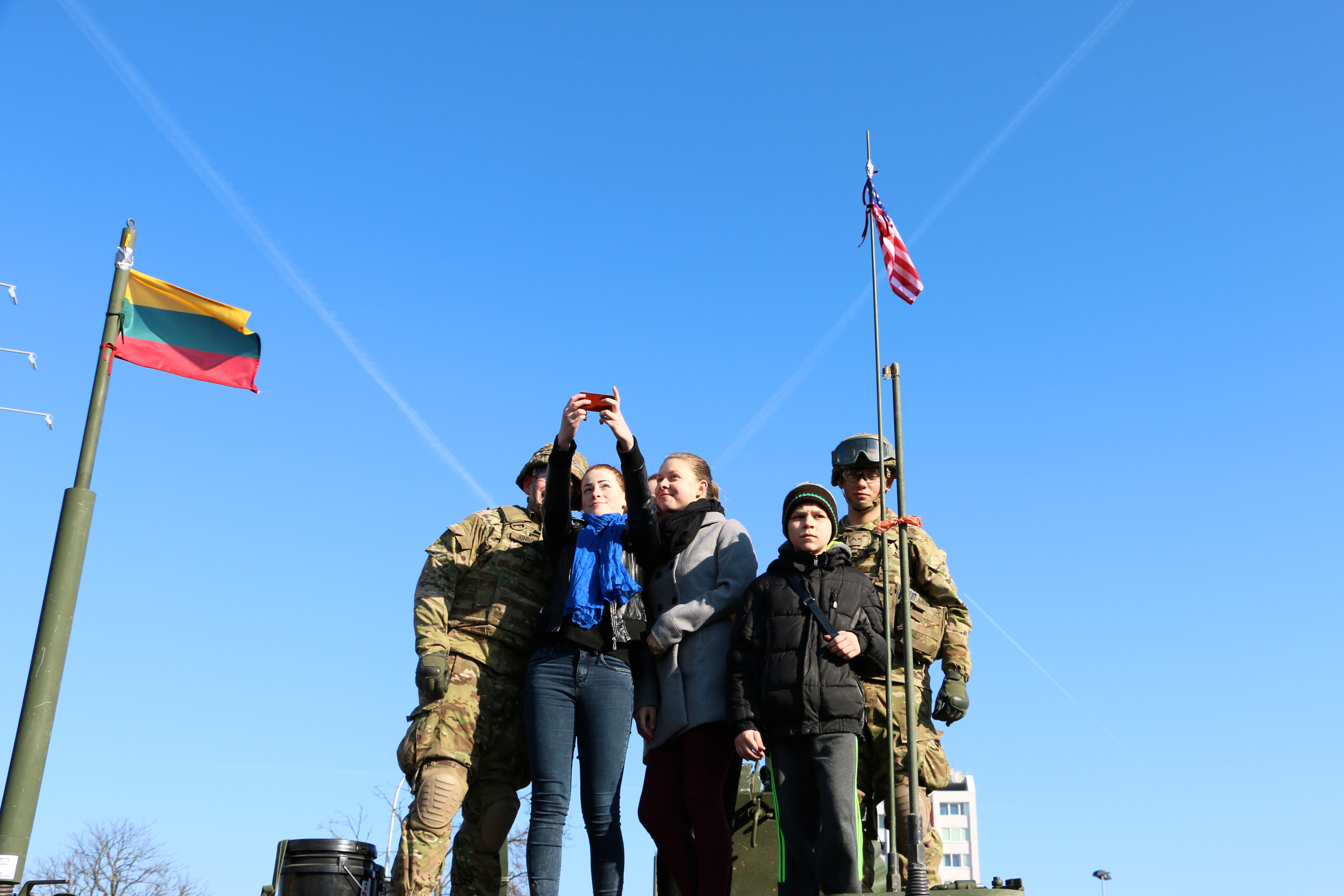 Lithuanians pose with U.S. Army soldiers at a U.S. Army Stryker static display in Marijampole, Lithuania on March 24.(Photo: Nolan Peterson/The Daily Signal)