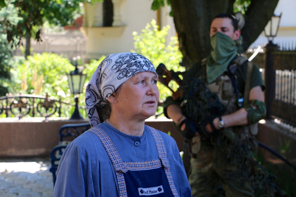 An Orthodox nun hands out chocolate and water to Ukrainian soldiers. (Photo: Nolan Peterson/The Daily Signal)