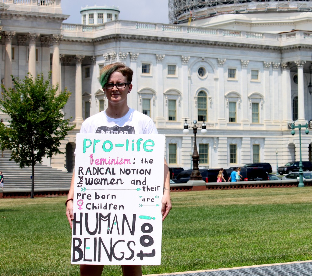 Twig, 26, has been a part of the pro-life movement since she was 14 years old. “I see something wrong and I just decide I’ll make a sign about it, although this one was made by someone who has better handwriting than I do,” Twig said. (Photo: Samantha Reinis/The Daily Signal)