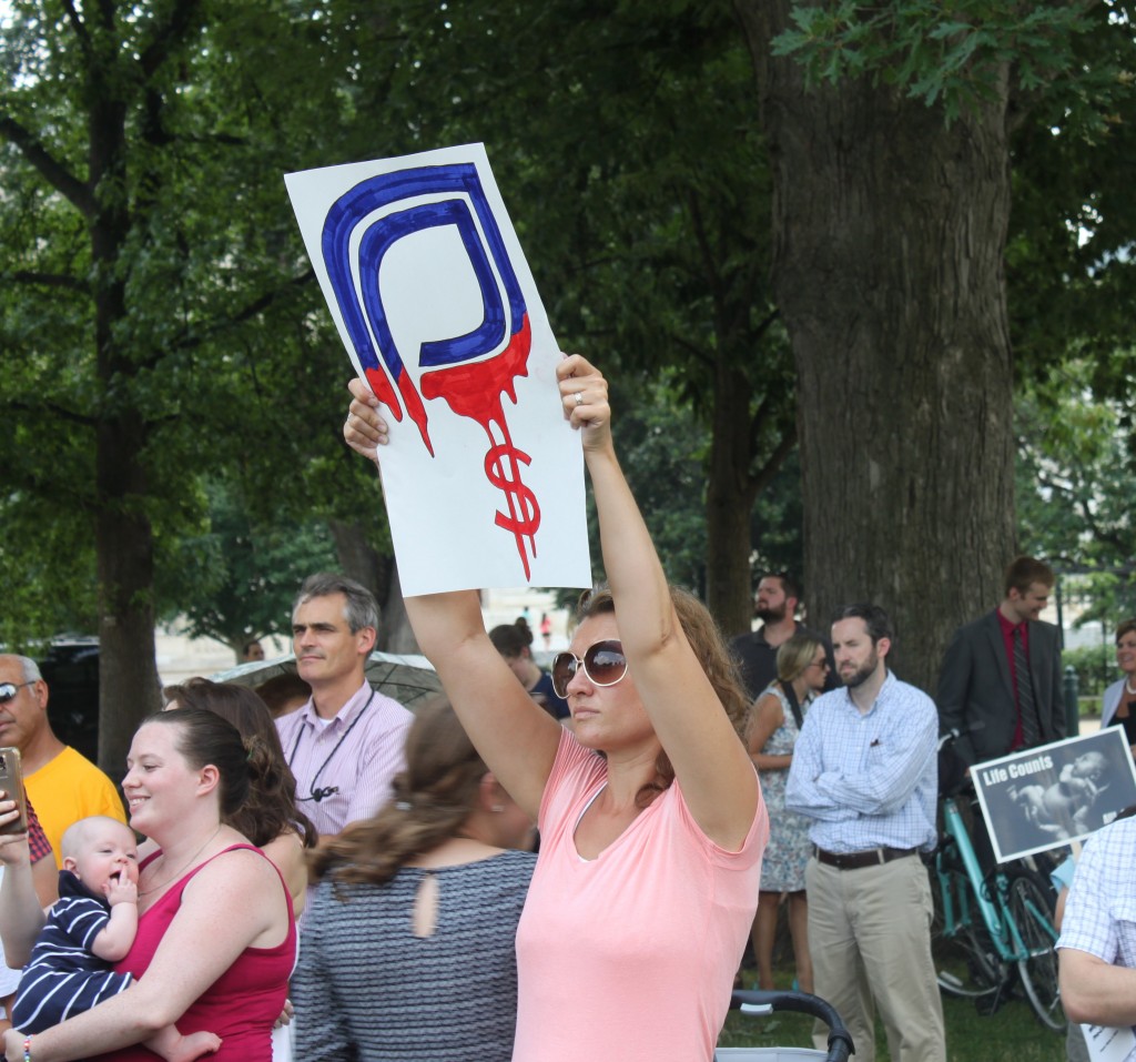 One woman at the #WomenBetrayed rally modified the Planned Parenthood logo. (Photo: Samantha Reinis/The Daily Signal)