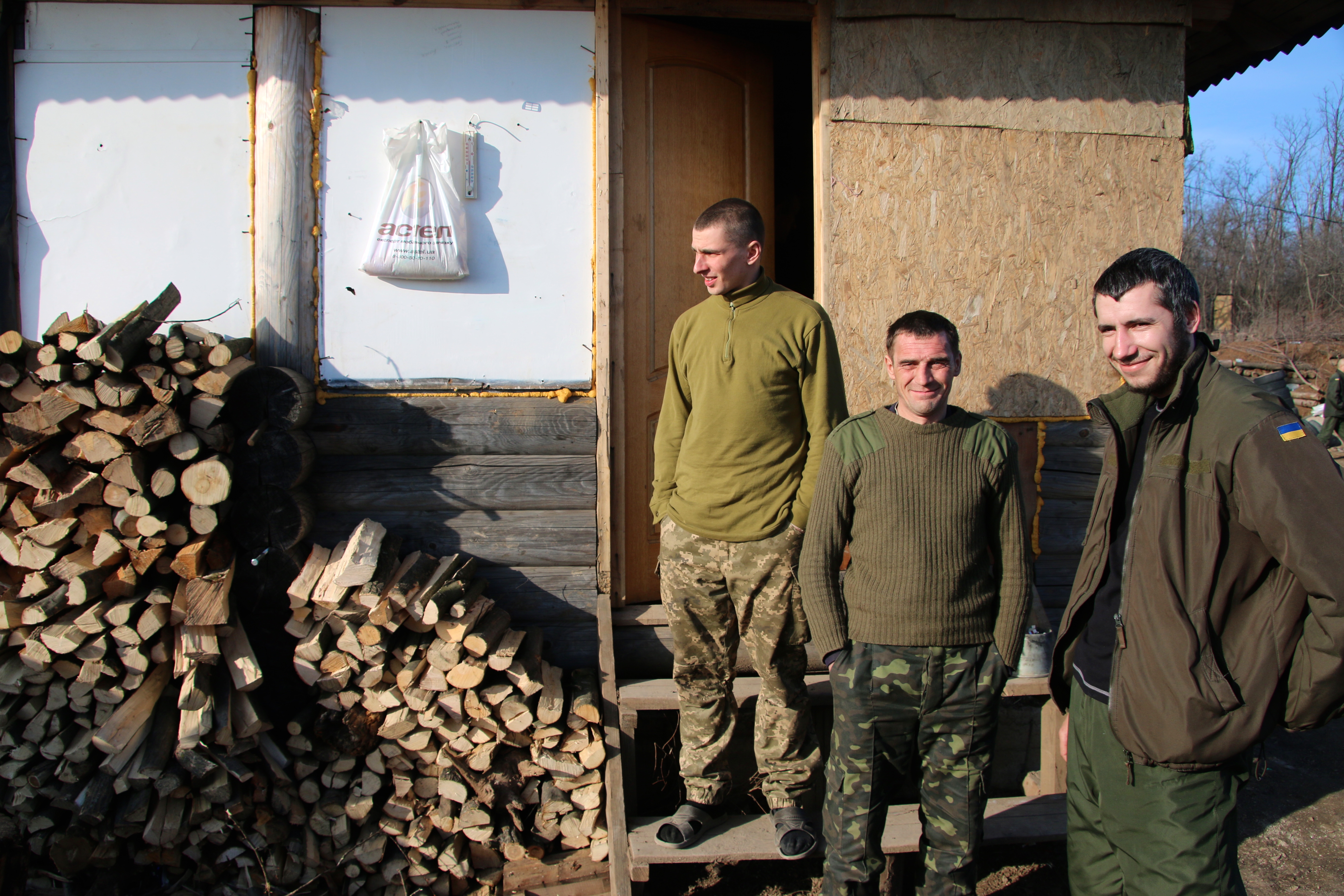 With the sounds of artillery in the background, Ukrainian soldiers in Karlivka appear relaxed and at ease.