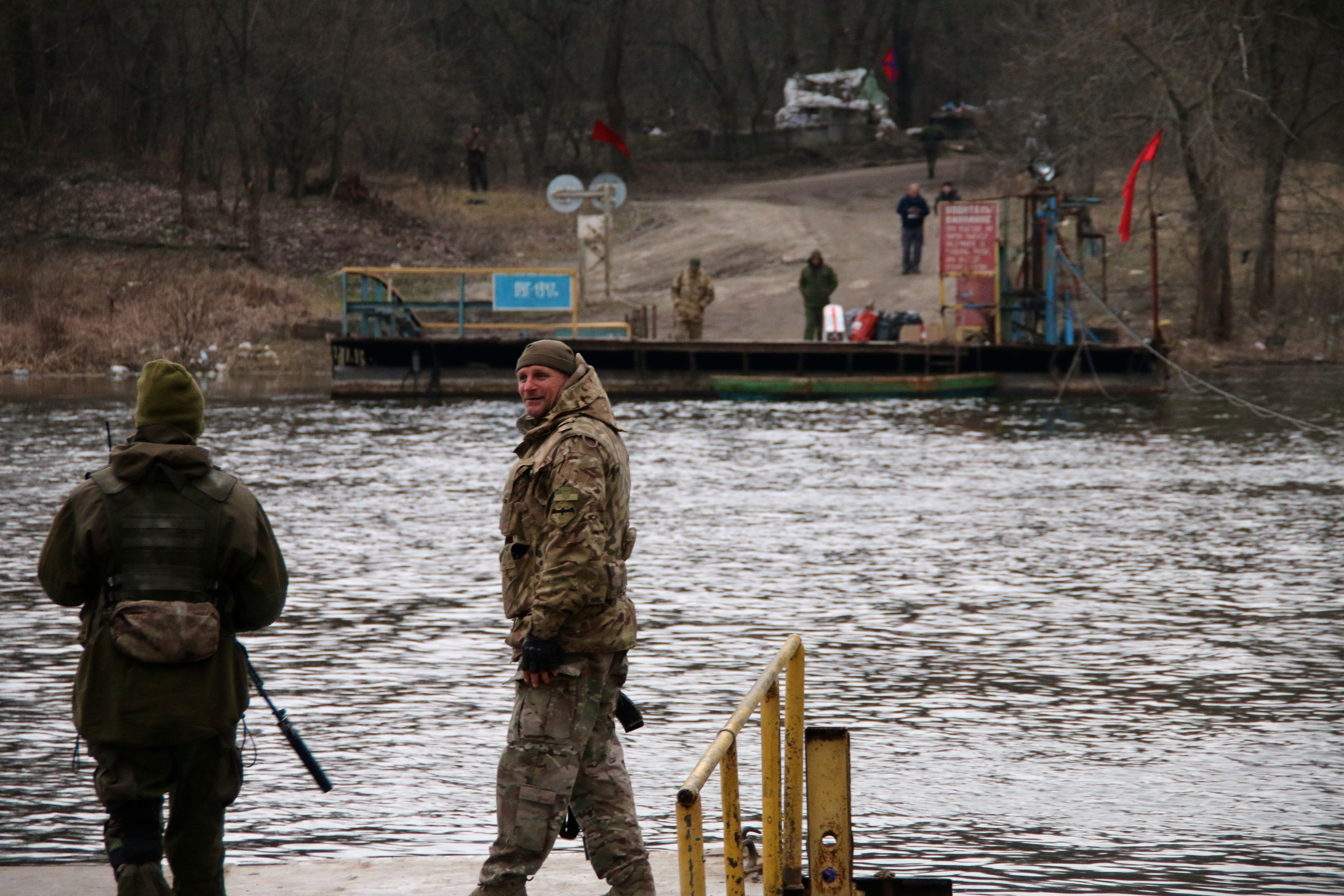 Ukrainian soldiers across a river from their enemies in the front-line town of Lobacheve.