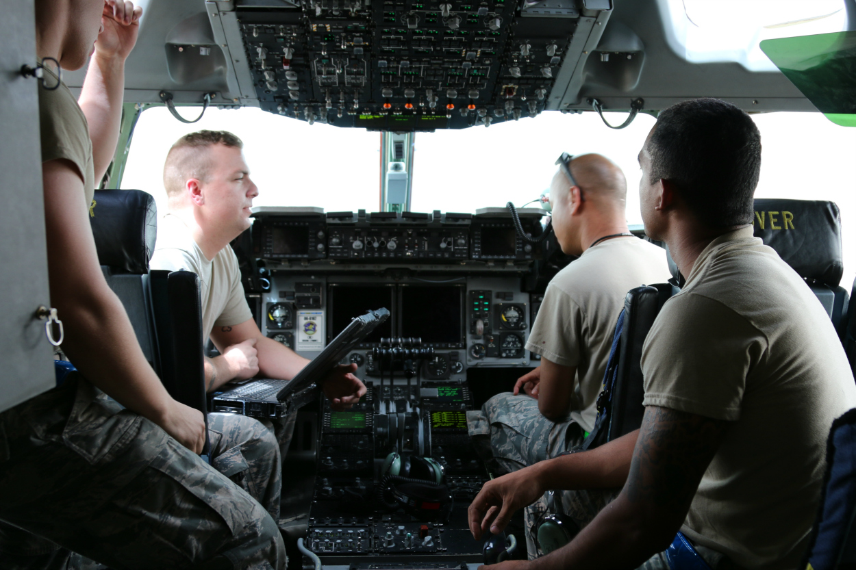U.S. Air Force personnel perform ground checks in the cockpit of a C-17 cargo plane at an undisclosed location in the Persian Gulf region. 