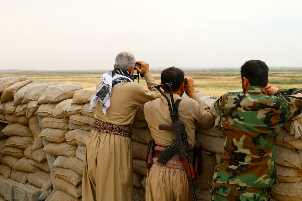 Peshmerga soldiers observe ISIS positions at a front line position south of Mosul.