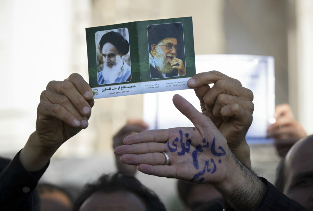 An Iranian man holds-up portraits of Iran's Late Leader Ayatollah Ruhollah Khomeini (left) and Supreme Leader Ayatollah Ali Khamenei. (Photo: Morteza NikoUbazl/SIPA/Newscom)