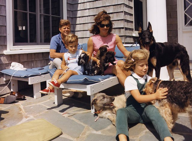 The Kennedy family poses with their dogs at Hyannisport: Irish spaniel Shannon, Welsh terrier Charlie, German shepherd Clipper, and the pups of Pushinka, who was a gift to Caroline from Soviet premier Nikita Khrushchev. (Photo: Newscom)