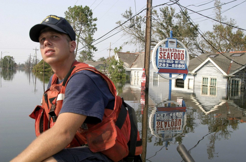US Coast Guardsman Neil Hebert surveys a stricken neighborhood during search and rescue operations in New Orleans. (Photo: Bartlett/SIPA/Newscom)