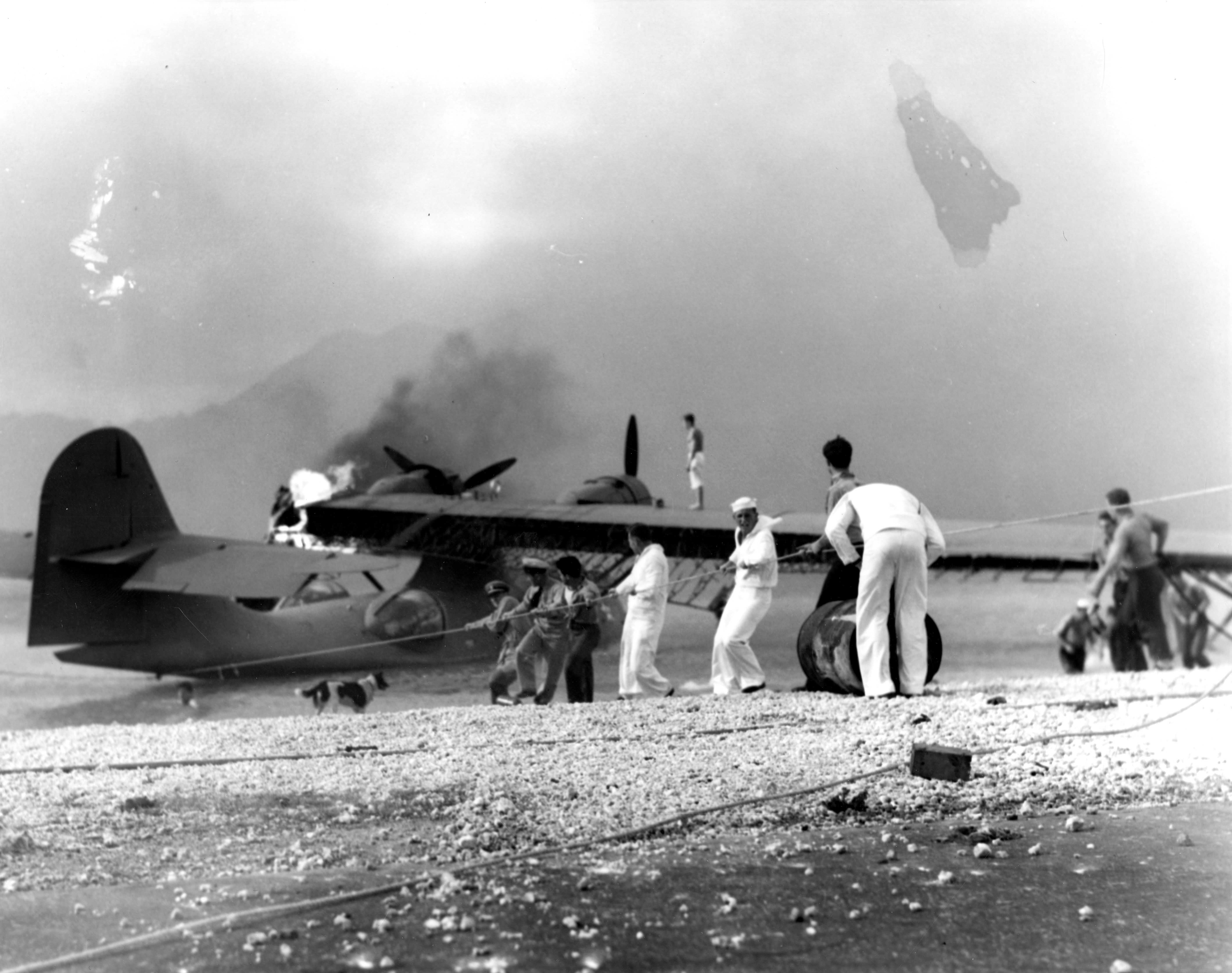 Sailors attempt to save a burning amphibious aircraft at during the Japanese attack on Pearl Harbor. (Photo: Handout/Reuters/Newscom)