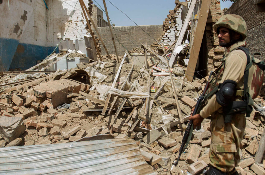A Pakistani soldier stands near the debris of a house destroyed during a military operation against Taliban militants in Miranshah, North Waziristan, July 9, 2014. (Photo: Stringer/Pakistan/Reuters/Newscom)
