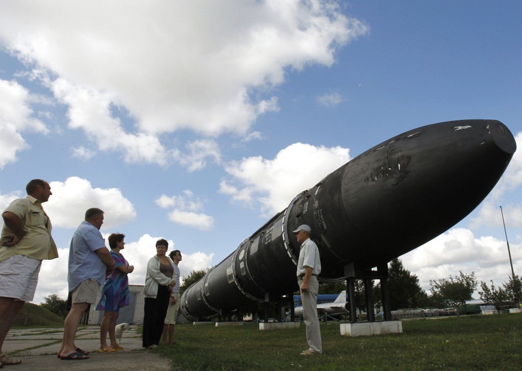 Visitors look at a SS-18 SATAN intercontinental ballistic missile at the Strategic Missile Forces museum near Pervomaysk
