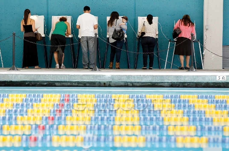 Voters cast their votes at the Echo Park Deep Pool being used as polling place in Los Angeles. (Photo: Newscom)