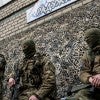 Fighters from the Ndipro 1 battalion sit outside a summer camp now acting as their barracks outside Volnovakha, Ukraine. (Photo: Tommy Trenchard/Polaris/Newscom)