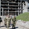 People walk past debris of a destroyed building near Donetsk Airport just outside Donetsk, Ukraine. (Photo: Newscom)