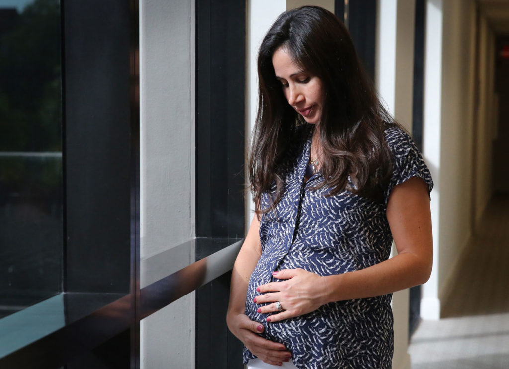 Maggie Arias, a Miami resident who is 23-weeks pregnant with her first baby, says she is concerned about the Zika outbreak in her community. (Photo: Emily Michot/Miami Herald/TNS/Newscom) 